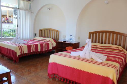 Postel nebo postele na pokoji v ubytování Hotel Barlovento