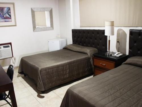 Hotel America Palacio tesisinde bir odada yatak veya yataklar