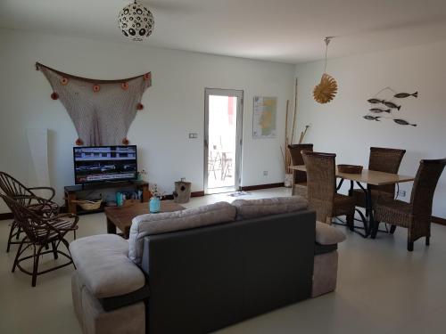 a living room with a couch and a table at Playa de Consolaçao in Consolacao