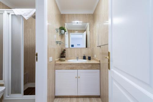 a bathroom with a sink and a mirror at Amarre Ocean in Puerto de Mogán