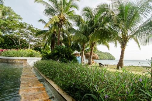 a resort with palm trees and a body of water at Villa Marina Lodge & Condos in Playa Venao