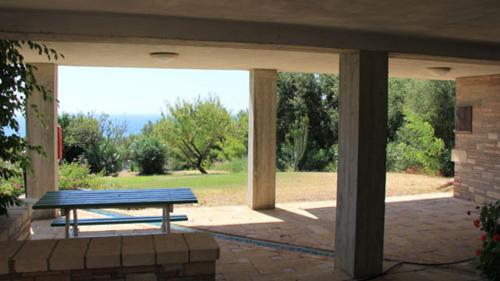a picnic table in a patio with a view of a park at Borgo Piazza in Catanzaro Lido