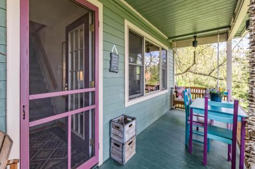 a porch with a table and chairs on a house at Moonshadow B&B in Hammondsport