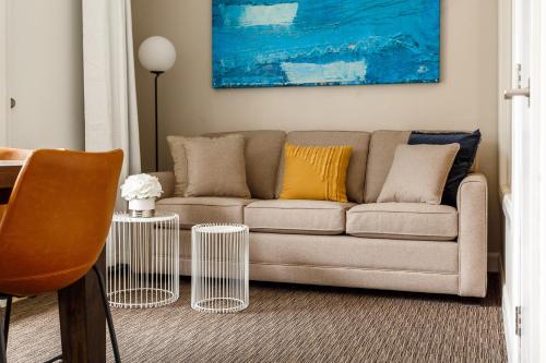 a living room with a couch and a table at Parc Avenue Lofts in Montréal