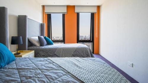 מיטה או מיטות בחדר ב-Miyana Condos by LiveMexicoCity