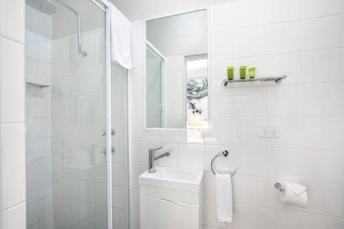 a white bathroom with a sink and a shower at Nightcap at Colyton Hotel in Colyton