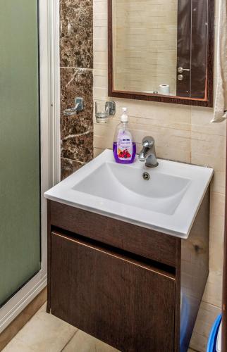 a bathroom with a white sink and a shower at Appartement Panoramique in Casablanca