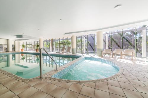 a large swimming pool in a hotel lobby at The Meriton Apartments on Main Beach in Gold Coast