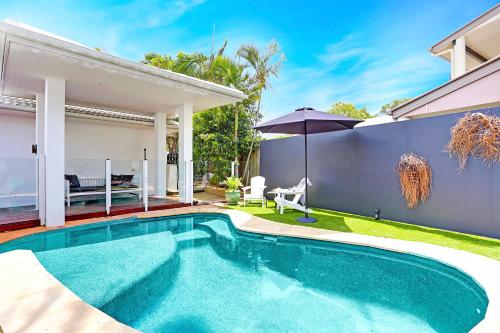 a swimming pool in the backyard of a house at Birdsong in Sunrise Beach