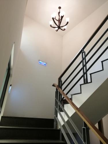 a staircase in a house with a chandelier at Shan-Yue Hotspring Hotel in Taipei