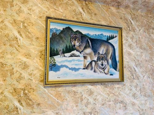 a painting of wolves on a wall at Horeka Hotel in Ulaanbaatar