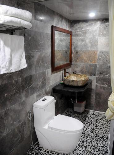 a bathroom with a toilet and a sink at Hoi An Mountain House Villa in Hoi An