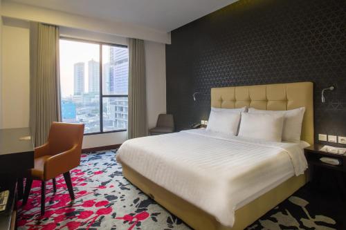 Säng eller sängar i ett rum på Liberty Hotel Thamrin Jakarta