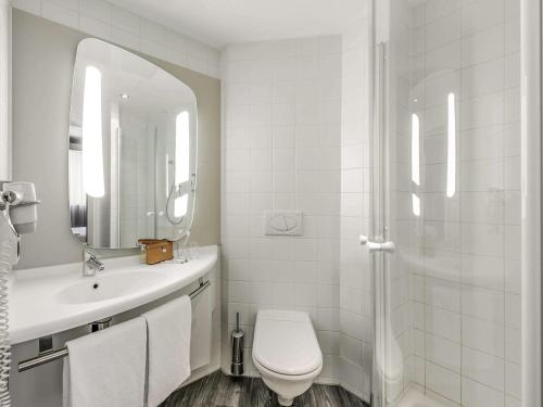 a bathroom with a toilet and a sink and a shower at ibis Paris Place d’Italie 13ème in Paris