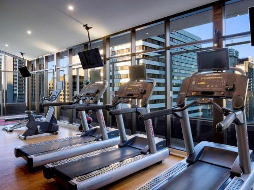 a gym with several tread machines in a building at Pullman Brisbane King George Square in Brisbane