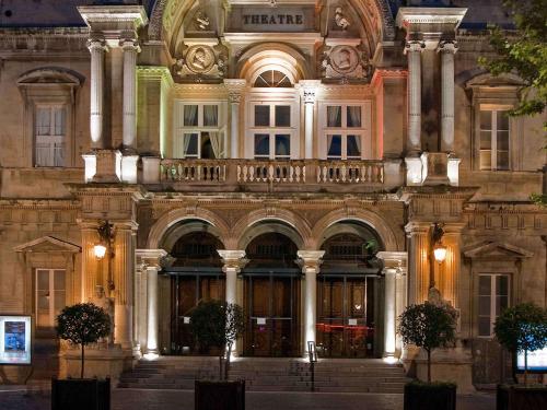 a large building with columns and a balcony at Mercure Avignon Centre Palais des Papes in Avignon