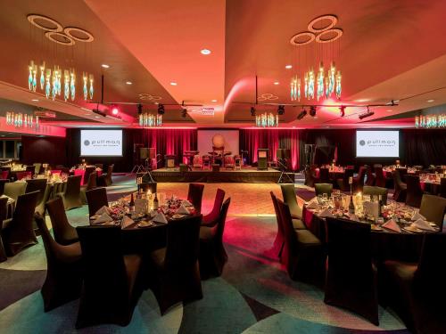 a banquet room with tables and chairs and a stage at Pullman Brisbane King George Square in Brisbane