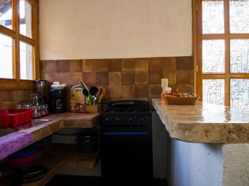 a kitchen with a stove and a counter top at Aldea Isla Sagrada in Cozumel