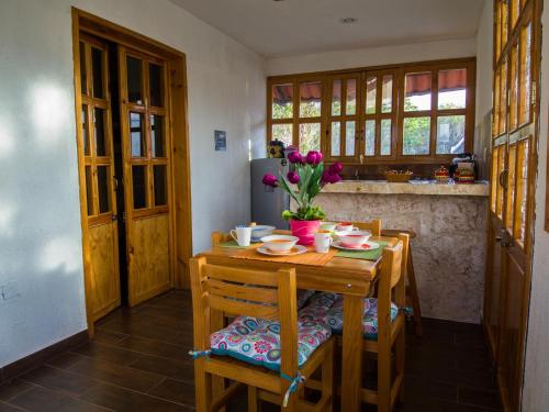 a kitchen with a wooden table with flowers on it at Aldea Isla Sagrada in Cozumel