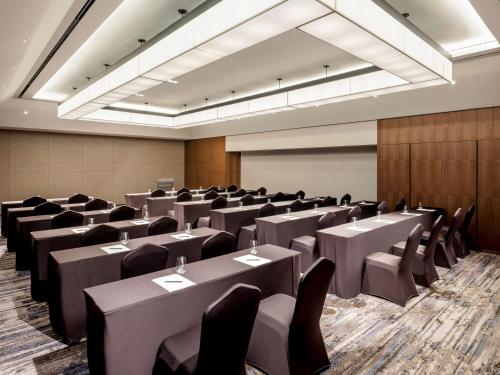 a conference room with tables and chairs in it at Novotel Suites Ambassador Seoul Yongsan in Seoul