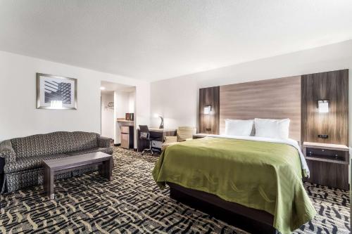 a hotel room with a bed and a desk at Quality Inn & Suites Augusta I-20 in Augusta