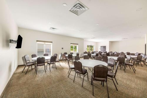 a conference room with tables and chairs and a podium at Sleep Inn Baxley in Baxley