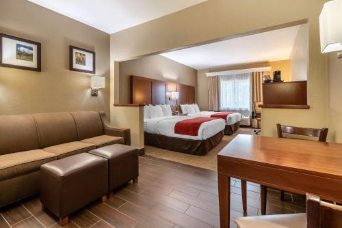 a hotel room with a bed and a couch at Comfort Suites Fort Collins Near University in Fort Collins