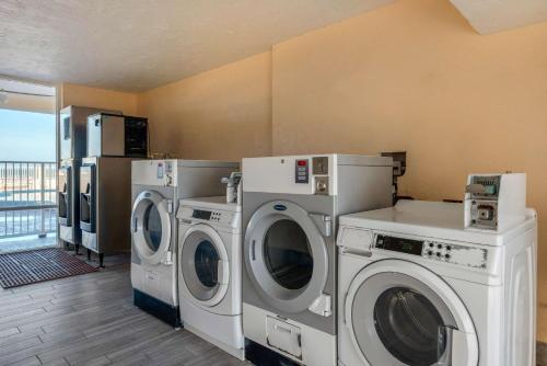 a laundry room with washing machines and a balcony at Quality Inn Daytona Beach Oceanfront in Daytona Beach