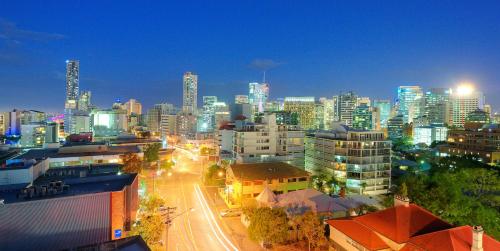 a view of a city at night with buildings at Summit Apartments Brisbane City in Brisbane