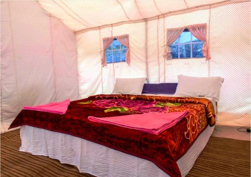 a bedroom with a bed in a tent at Julley World Camp in Nubra