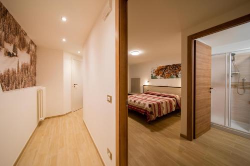 a bedroom with a bed and a sliding glass door at La Belle Epoque in Aosta