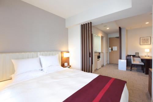 a hotel room with two beds and a television at Tokyu Stay Shibuya in Tokyo