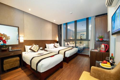 Postel nebo postele na pokoji v ubytování Saigonciti Hotel