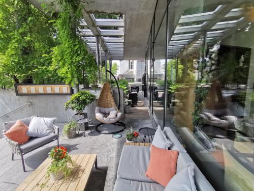 a patio with couches and plants in a building at Radisson Blu Hotel, St. Gallen in St. Gallen