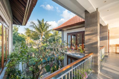 an open balcony with a view of a house at Prabhu Ubud Villa in Ubud