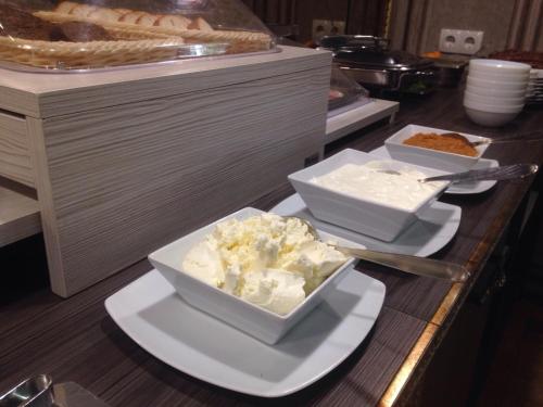three bowls of food on a counter in a kitchen at Hotel Villa Natali in Chişinău