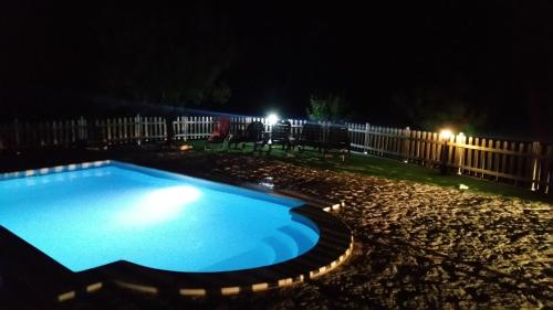 a swimming pool in a yard at night at Mas de Salvador in Peñarroya de Tastavins