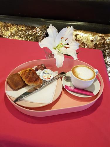 a tray with a cup of coffee and a plate of food at MAISON MARSIL - Boutique Hotel Köln in Cologne