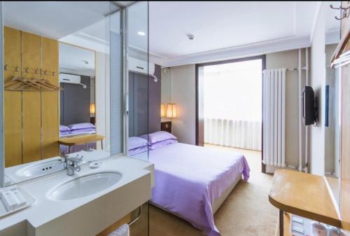 
a hotel room with two sinks and a large mirror at Beijing Aulympic Airport Hotel in Shunyi
