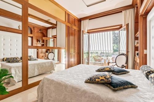 a bedroom with two beds and a large window at First Class Rome Apartments in Rome