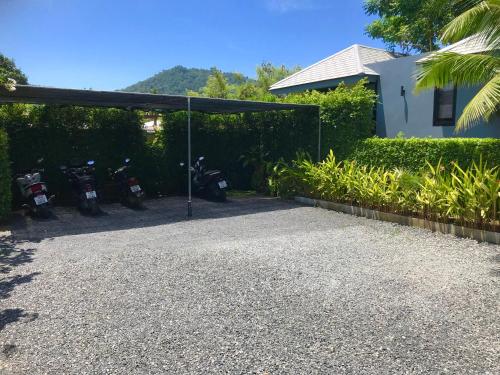 a group of motorcycles parked under a garage at Coco Layma Villa, Samui in Lamai