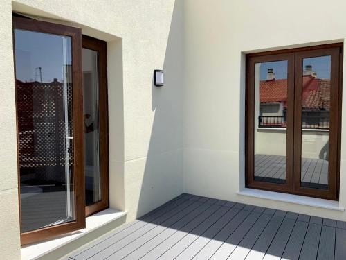 a balcony with a sliding glass door with a view of a building at New Point Opera in Madrid