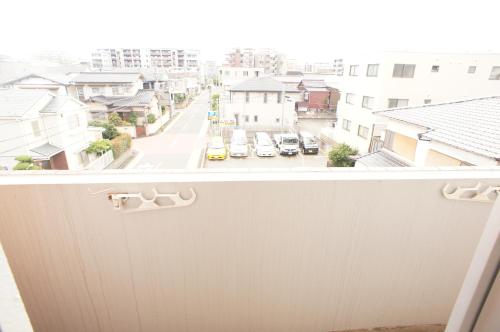 a view of a city street from a balcony at Plusone Fujisaki in Fukuoka