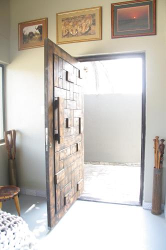 a door in a room with a brick wall at SelkieBnB in Walvis Bay
