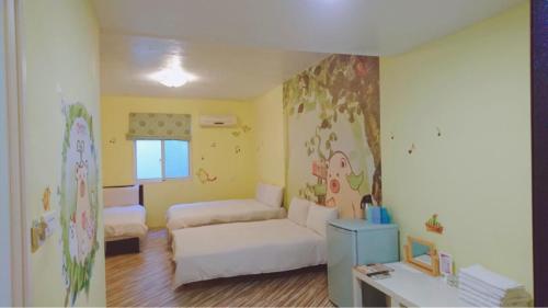 a living room with a couch and a bed in it at Fengjia Love I Hostel in Taichung