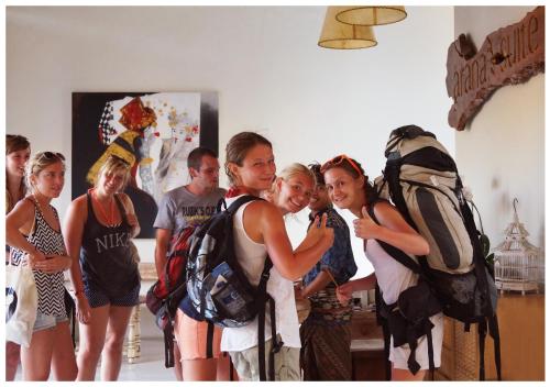 a group of people standing in a room with backpacks at Arana Suite in Legian