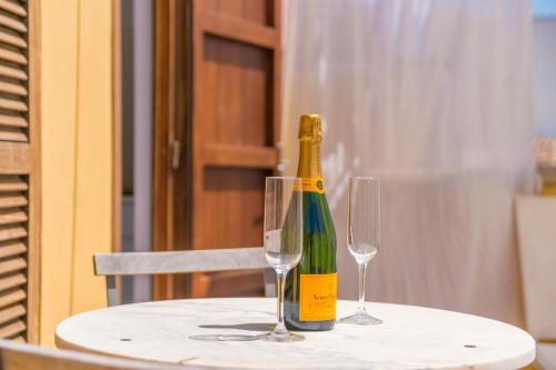 a bottle of wine sitting on a table with two glasses at Miraclet - ADULTS ONLY in Palma de Mallorca