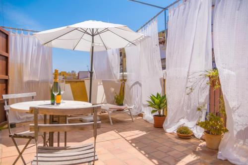 a patio with an umbrella and a table and chairs at Miraclet - ADULTS ONLY in Palma de Mallorca