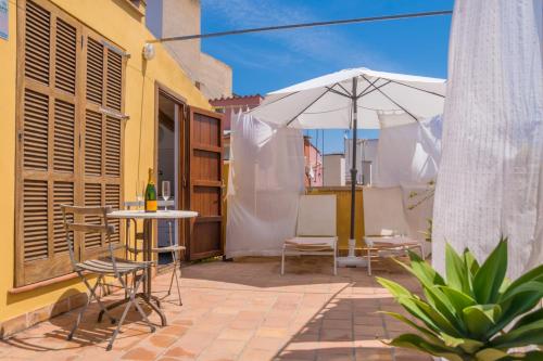 a patio with a table and an umbrella at Miraclet - ADULTS ONLY in Palma de Mallorca