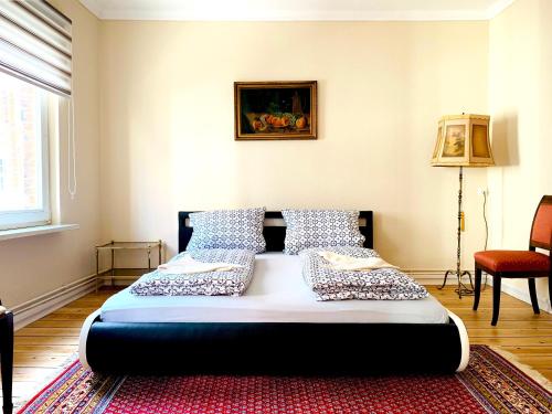 a bedroom with a large bed with pillows on it at Ferienwohnung Coco in Lübeck